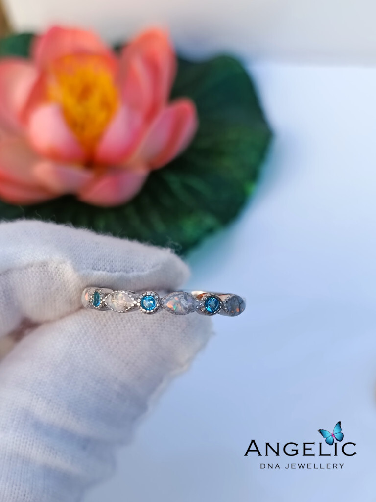 The Angelic Marquise Genuine Birthstones Ring, featuring alternating blue and clear genuine birthstones set in a silver band. The design showcases smooth marquise shapes, ideal for showcasing personalized styles.