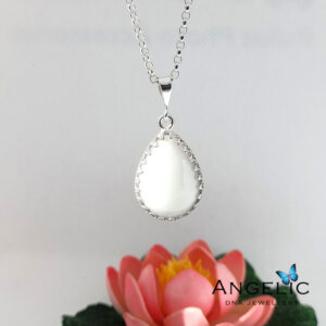 The Angelic Large Teardrop DNA Pendant features a silver chain with a large teardrop-shaped pendant, showcasing a polished white surface, framed with a decorative edge, suitable for everyday wear.