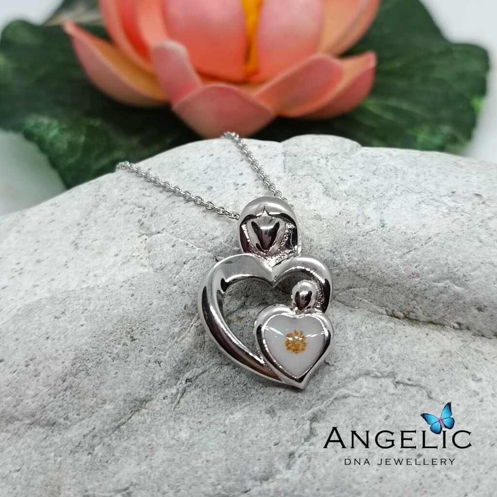 The Angelic An Grá DNA Pendant features a dual-heart design in polished silver, showcasing a smaller heart with a golden accent at its center, hung on a delicate chain. This pendant embodies sentimentality and elegance.