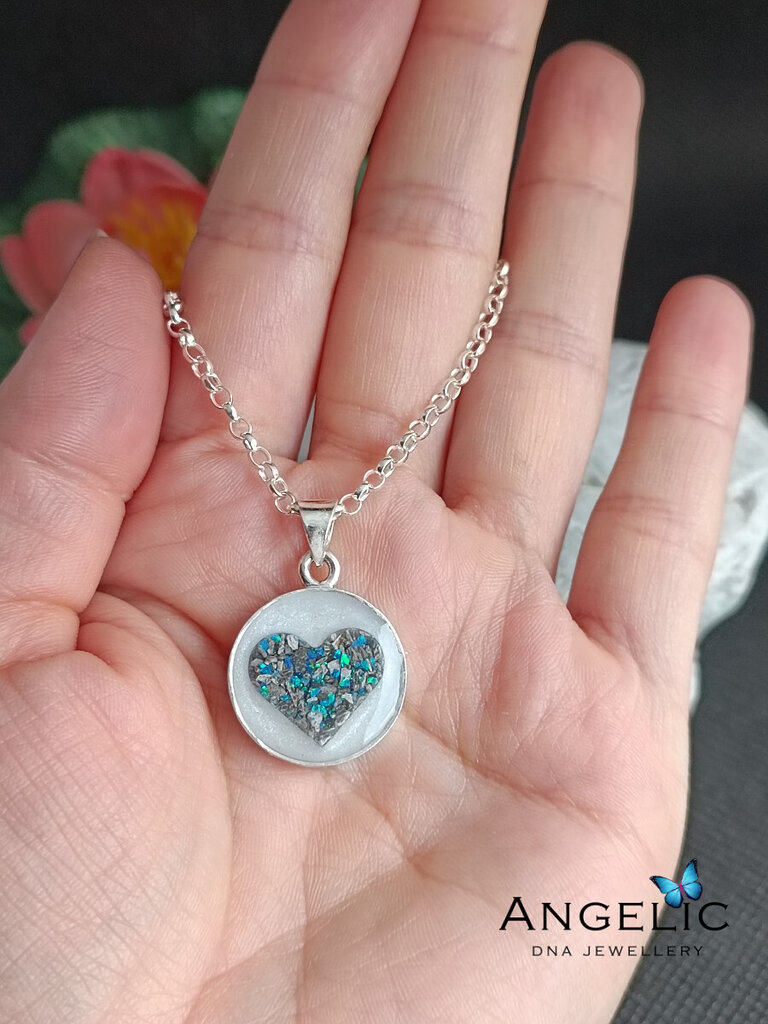 person holding one circle of life dna pendant on gold chain