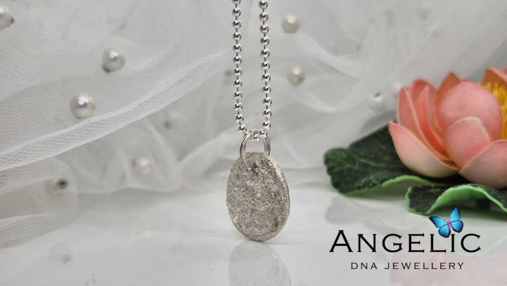 Sterling silver pendant necklace with intricate design, displayed against a soft, elegant background, showcasing the craftsmanship of Angelic Fine Jewellery.