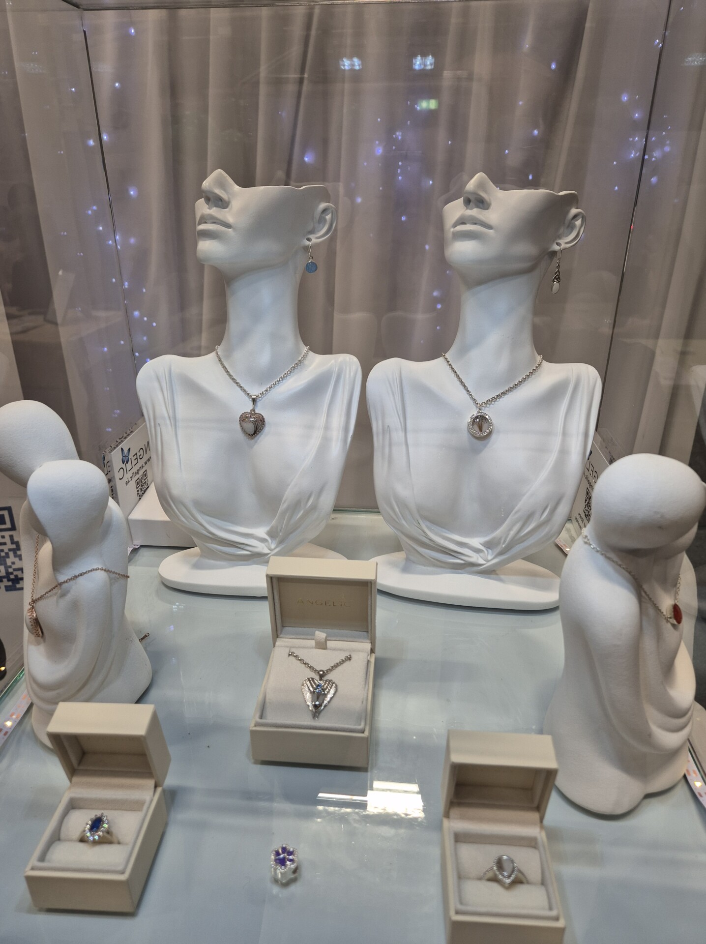 Close-up view of keepsake jewellery displayed on necklace busts inside Angelic DNA Jewellery&rsquo;s showcase cabinet at the Mind Body Experience Dublin.